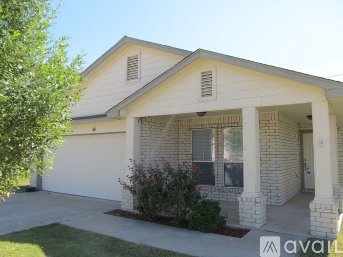 A house with a white garage door and a brick exterior.