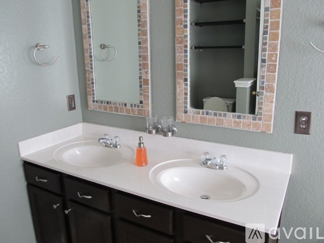 A bathroom with two sinks and a mirror.