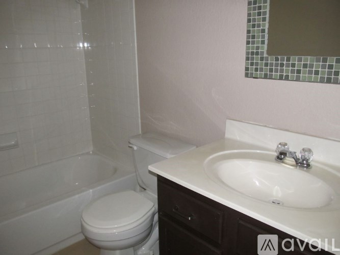 A white toilet sits next to a sink in a bathroom.