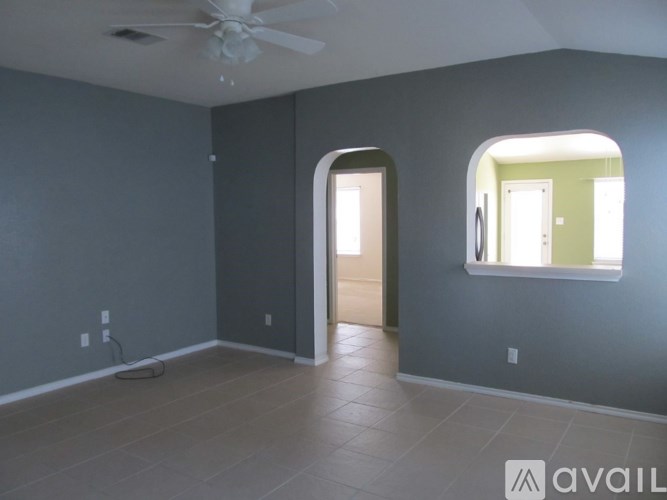 A room with a ceiling fan and a window.