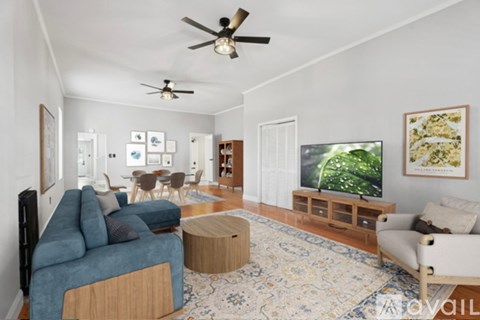 A living room with a blue couch and a television.