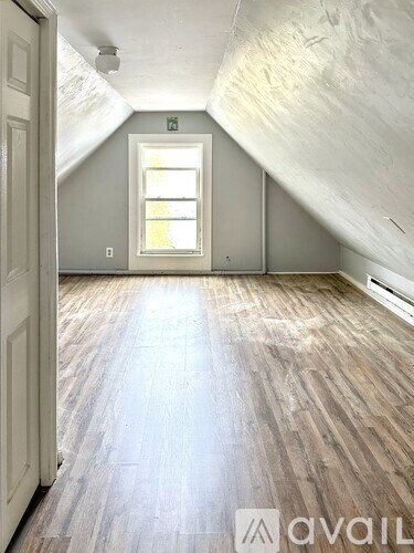 A room with wooden floors and a window.