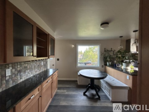 A kitchen with a table and a window.