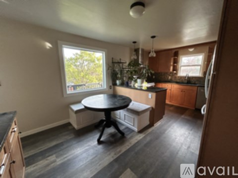 A kitchen with a round table and a window.