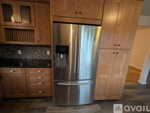 A small bathroom with a toilet, sink and mirror.