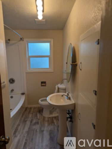 A room with wooden floors and a green sign on the wall.