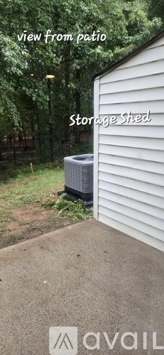 A storage shed is seen from a patio.
