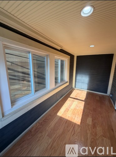 A room with wooden floors and a window.