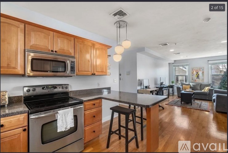 A kitchen with wooden cabinets and a black stove top oven.