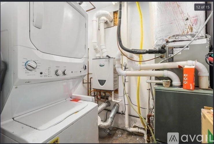 A white oven with a yellow caution tape on the floor.