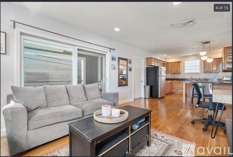 A living room with a grey couch and a coffee table.