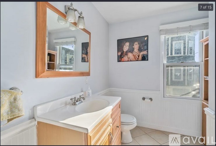 A bathroom with a white sink and a mirror above it.