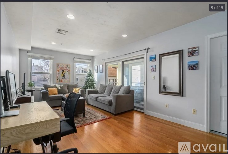 A living room with a couch, chair, and a table.