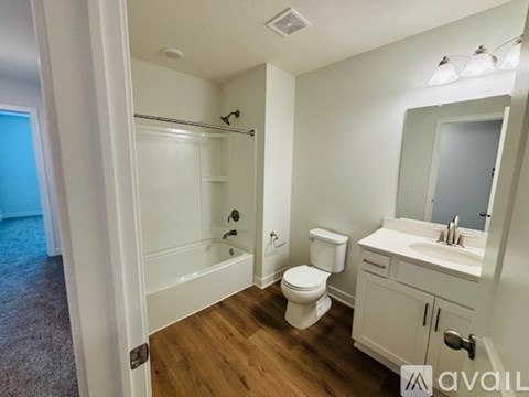 A bathroom with a toilet, sink, and shower.