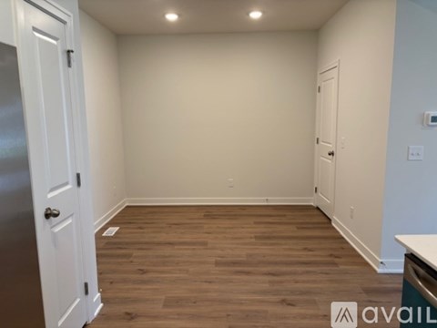 A room with wooden floors and white walls.