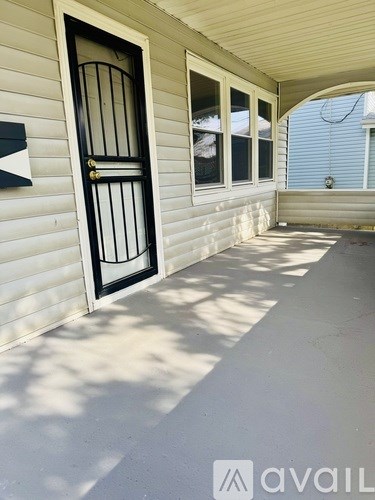 A white house with a black door and window.