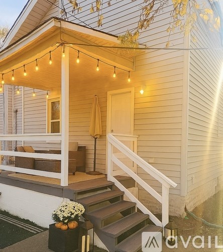 A room with wooden flooring and a fireplace.