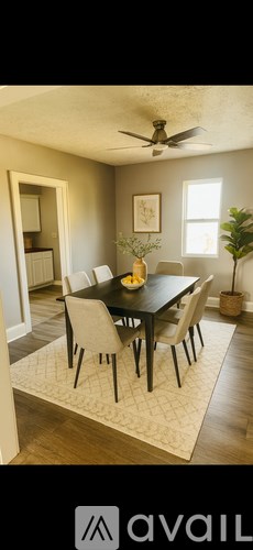 A dining room with a table and chairs.