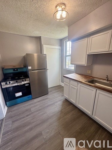 A kitchen with a stainless steel refrigerator and oven.