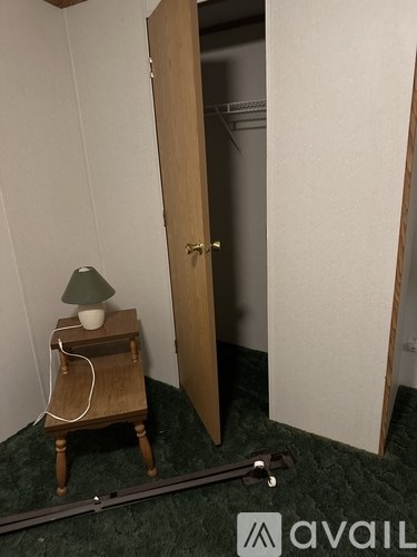 A lamp on a table in a room with a door.
