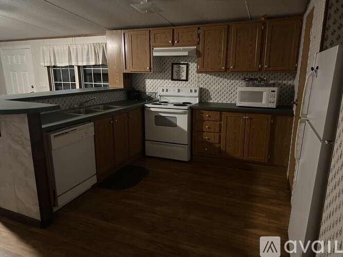 A kitchen with wooden cabinets and a white fridge.