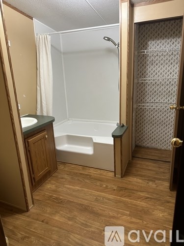 A bathroom with a bathtub and a toilet.