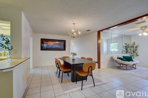 A dining room with a table set for four.