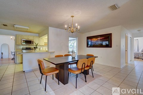 A dining room with a table and chairs.