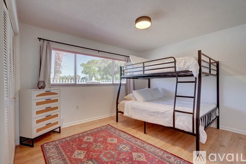 A bedroom with a bunk bed and a dresser.