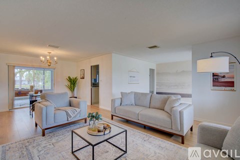 A living room with a couch, chair, and coffee table.