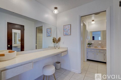 A bathroom with a vanity and a mirror.