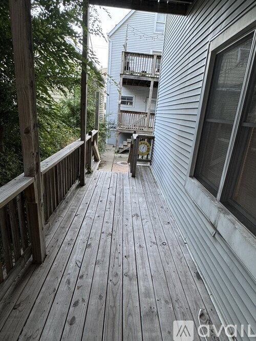 A wooden deck with a railing and a clock on it.