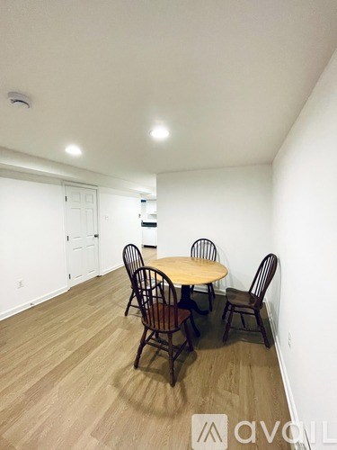 A room with a table and chairs in it.