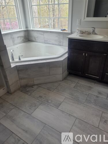 A bathroom with a tub and a sink.