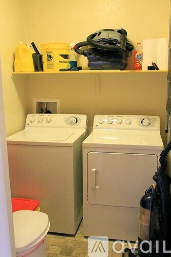 A small laundry room with a washer and dryer.
