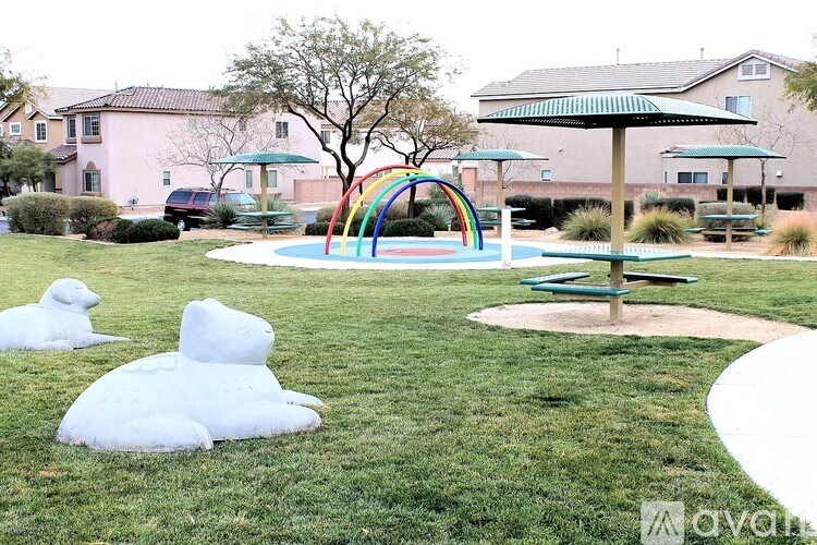A playground with a slide, swings, and a sandbox.