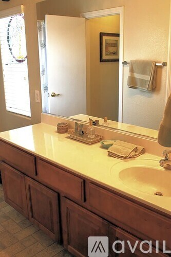A bathroom with a sink and a mirror.