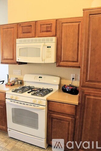 A white stove and microwave in a kitchen.