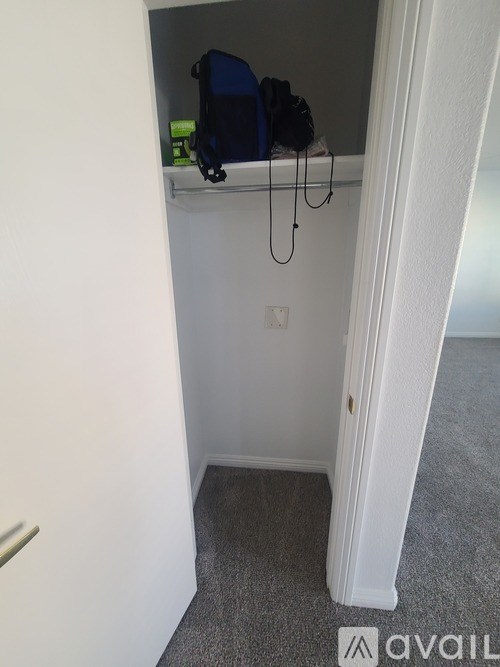 A small room with a shelf and a chair.