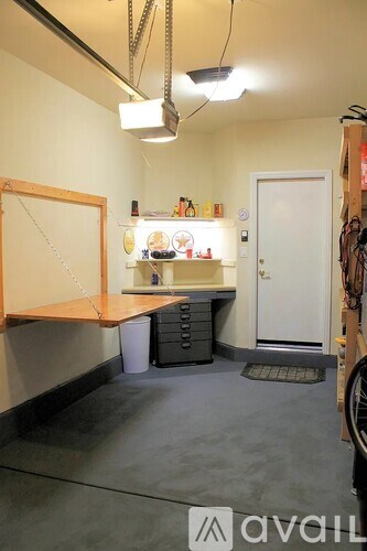 A room with a desk and a white door.