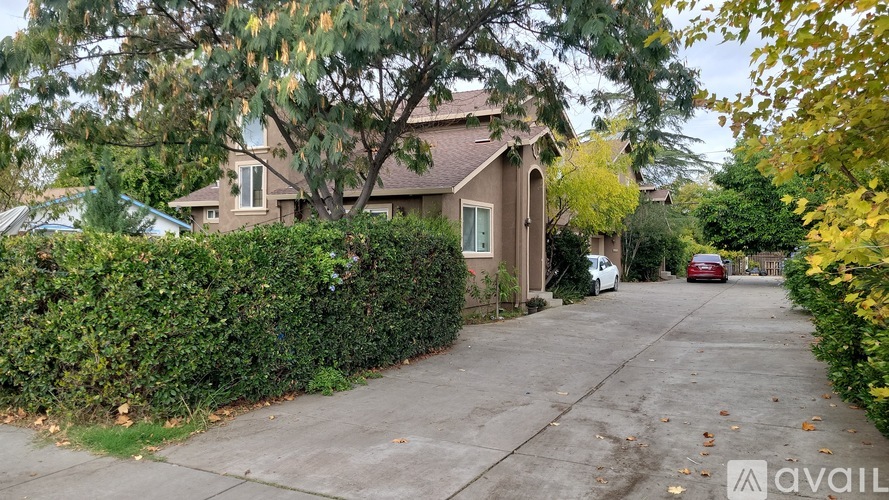 A house with a driveway and a car parked in front.