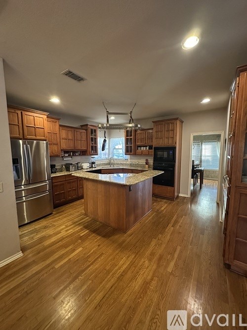A kitchen with wooden cabinets and a central island.