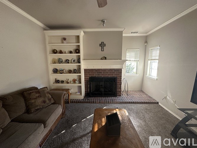 A living room with a fireplace and a couch.