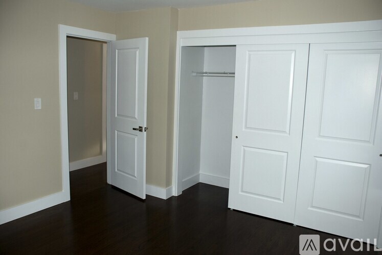 A room with a white door and a white cabinet.