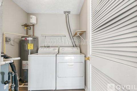 A small laundry room with a washer and dryer.