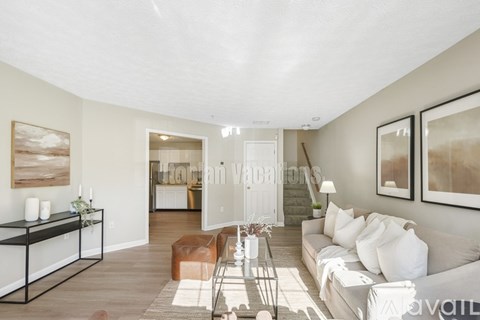 A living room with a white couch and a coffee table.