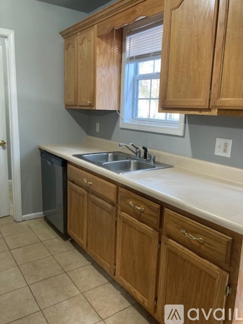 A kitchen with wooden cabinets and a white countertop.