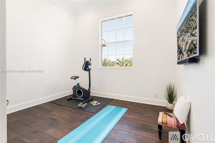 A room with a blue mat on the floor and a vacuum cleaner on it.
