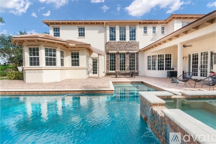 A large house with a pool in front.