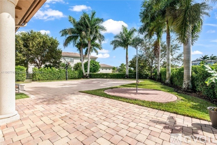 A brick walkway leads through a landscaped garden.